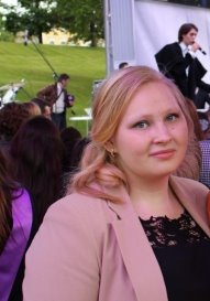 A person standing in front of a group of people posing for the camera

Description automatically generated