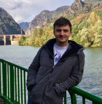 A person standing next to a body of water

Description automatically generated