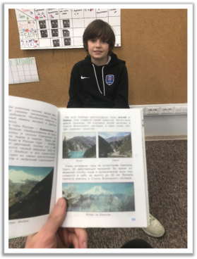 A person holding a book

Description automatically generated with medium confidence
